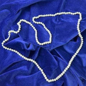 30 inch long hand knotted faux pearls.